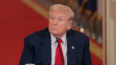 Donald Trump stares blankly while sitting