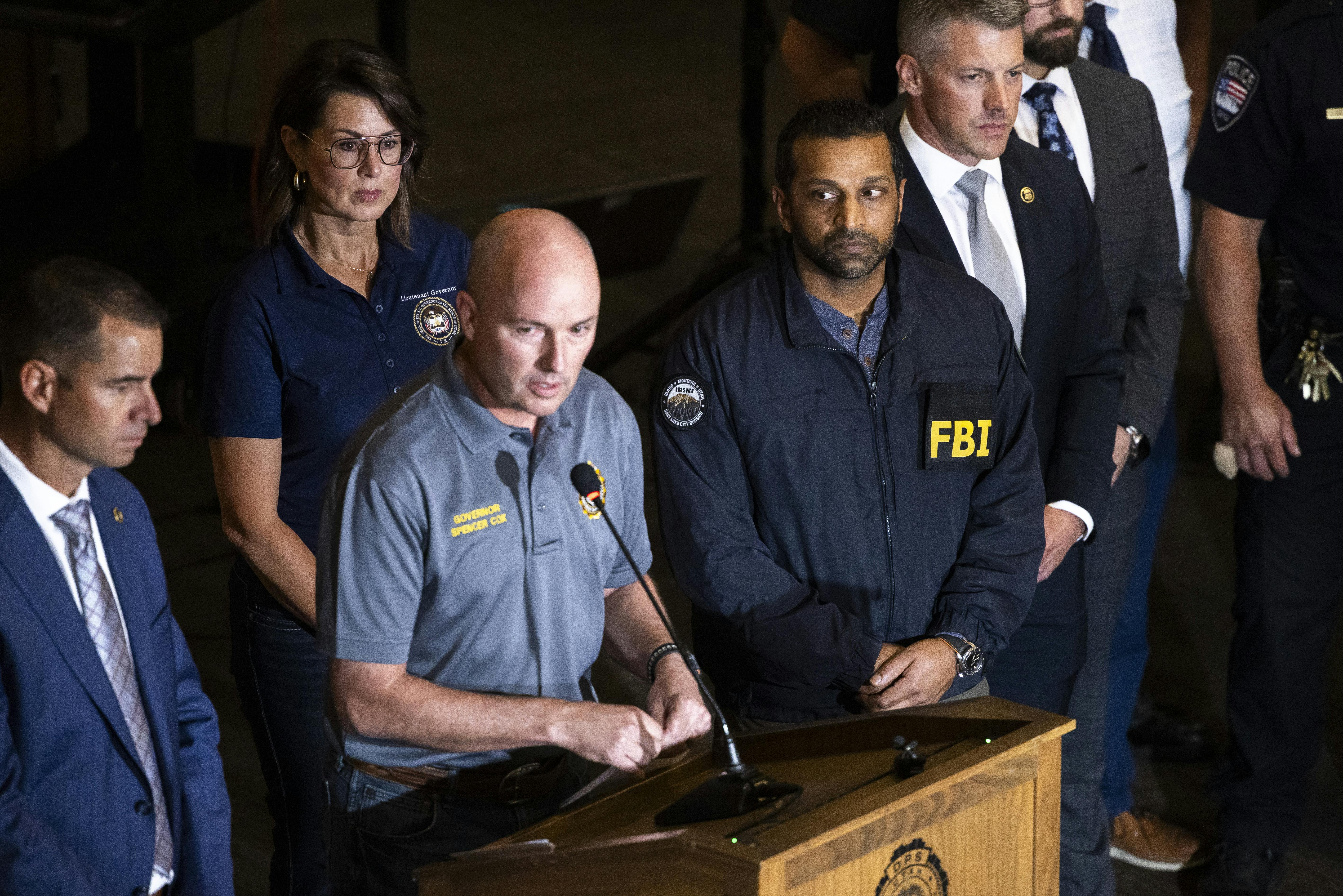 Utah Governor Spencer Cox speaks at a press conference flanked by FBI director Kash Patel, Lieutenant Governor of Utah Deidre Henderson, and Commissioner Beau Mason.