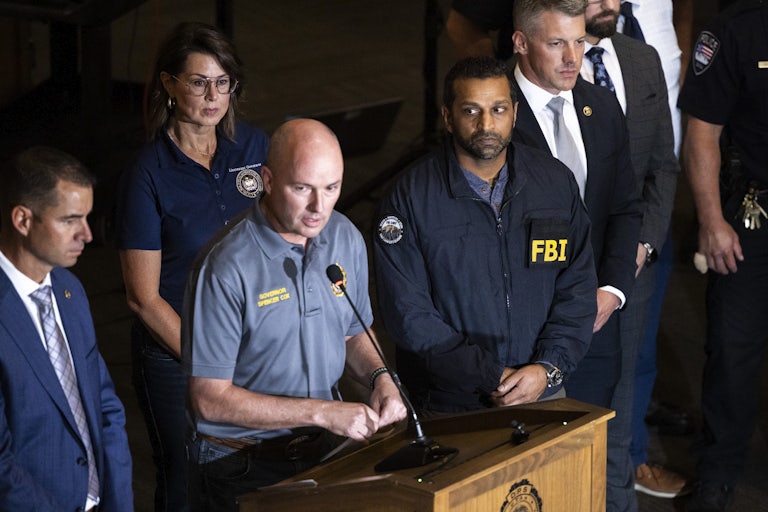Utah Governor Spencer Cox speaks at a press conference flanked by FBI director Kash Patel, Lieutenant Governor of Utah Deidre Henderson, and Commissioner Beau Mason.