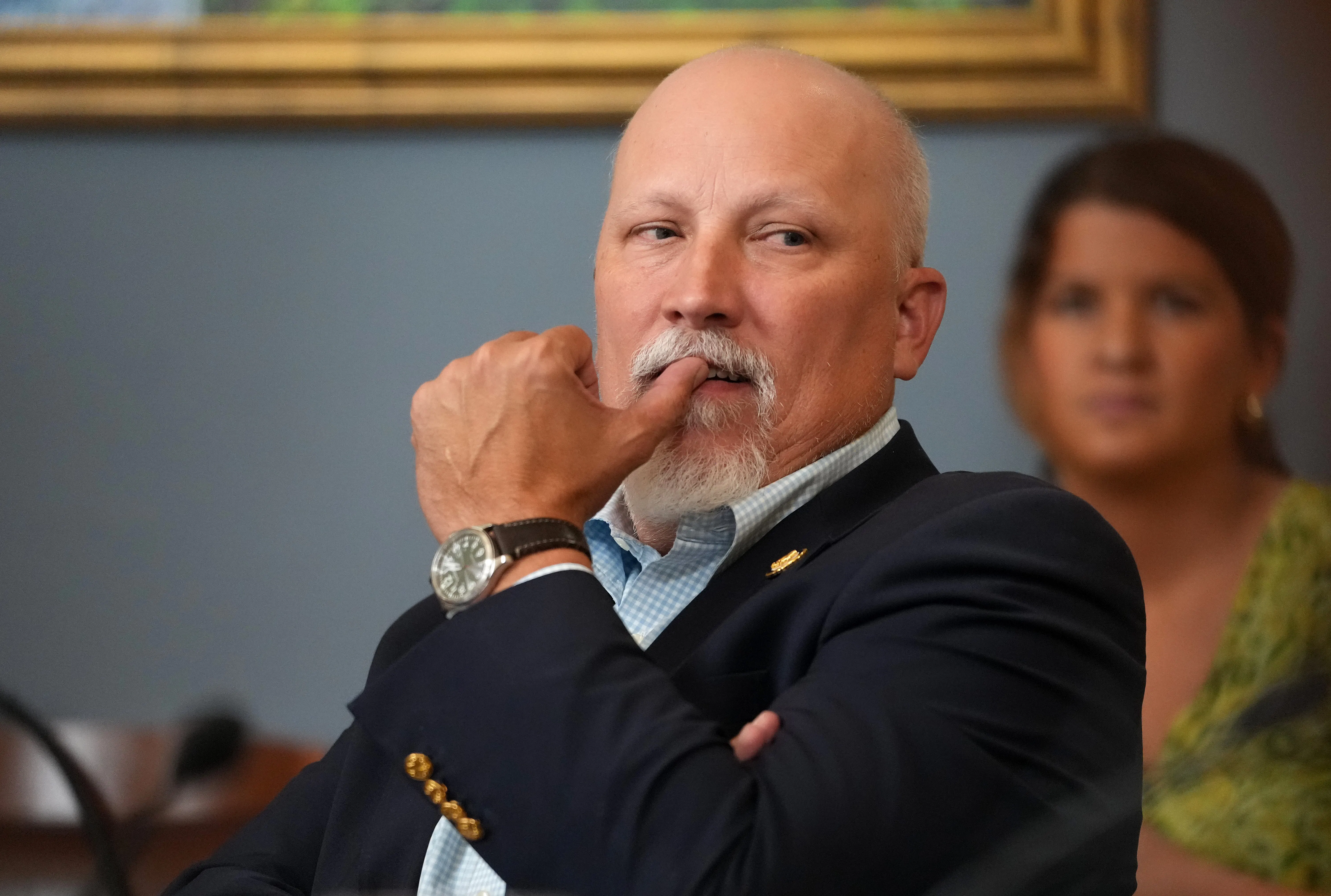 Representative Chip Roy puts his thumb on his mouth
