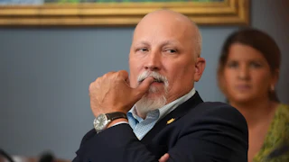 Representative Chip Roy puts his thumb on his mouth