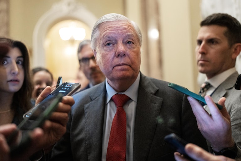 Senator Lindsey Graham is surrounded by reporters in the Capitol