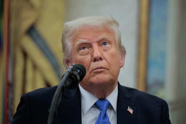 Donald Trump vacantly stares while speaking into a microphone