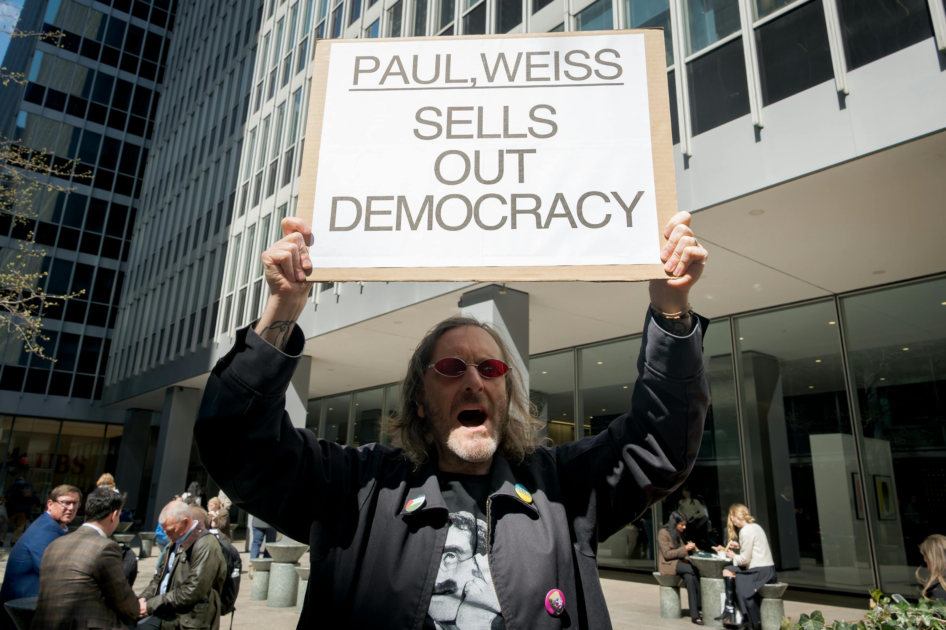 A group of protesters outside the offices of Paul, Weiss, in Manhattan
