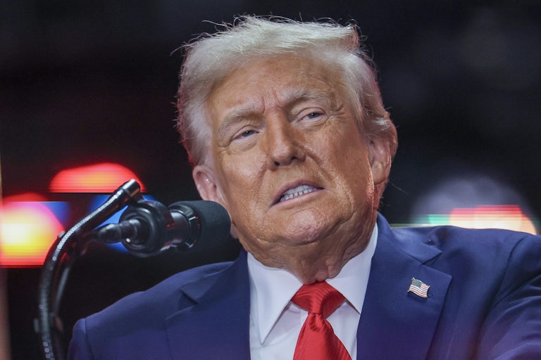 Donald Trump stands at a microphone during Charlie Kirk’s memorial service