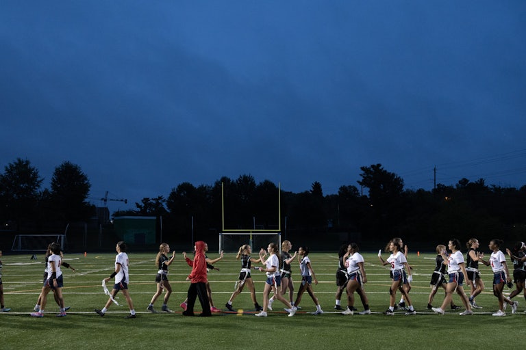 Girls high-five after a sports match