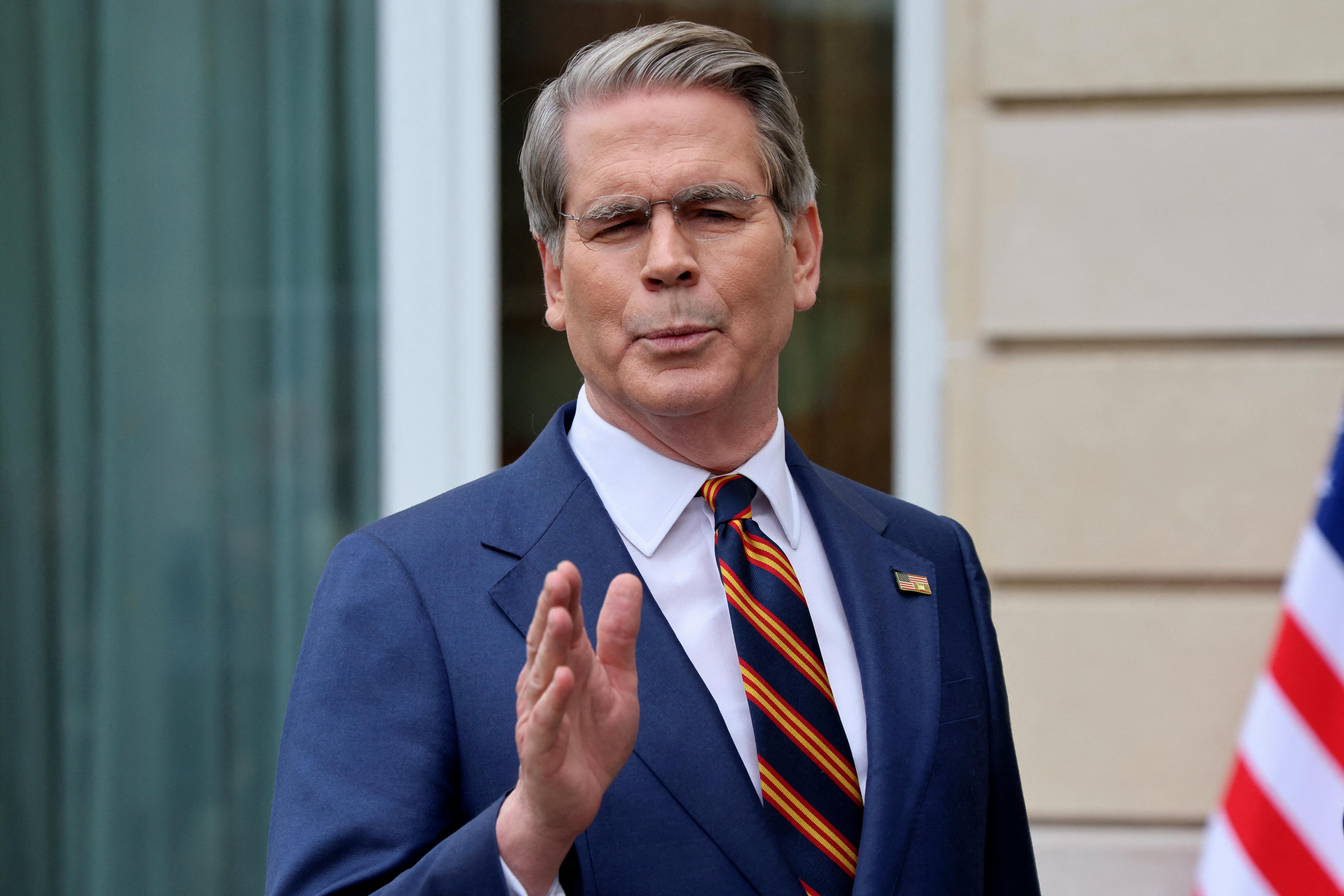 Treasury Secretary Scott Bessent gestures while speaking to reporters