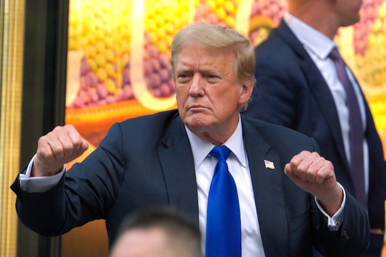 Donald Trump holds up his fists