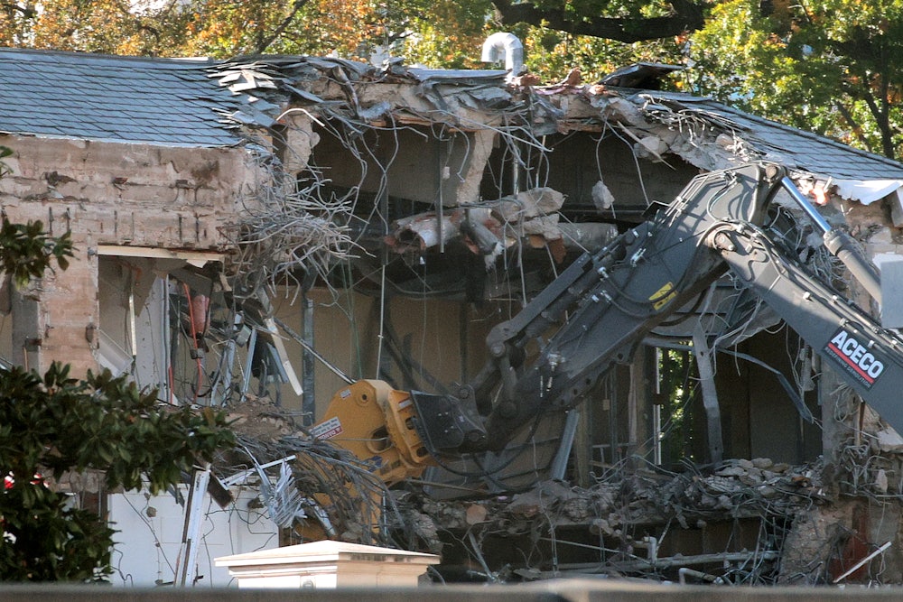 Workers demolish the facade of the East Wing of the White House.