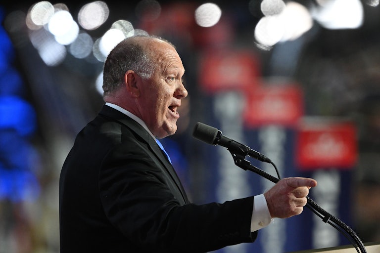Tom Homan speaks at a lectern.
