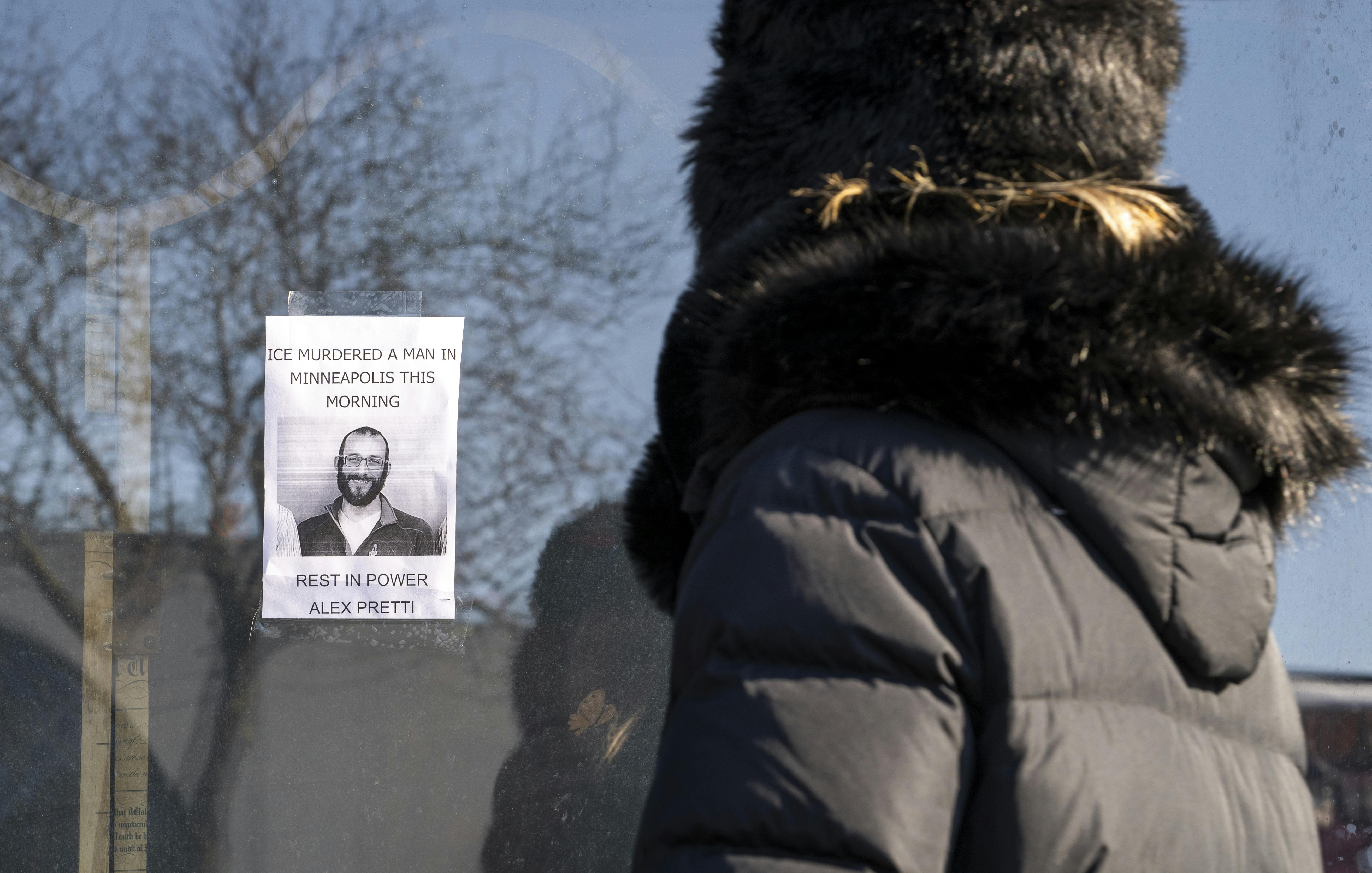 A person passes by a poster of Alex Pretti in Minneapolis. Pretti, an ICU nurse at a VA medical center, died on January 24 after being shot multiple times by U.S. Border Patrol agents in the Eat Street district of Minneapolis.