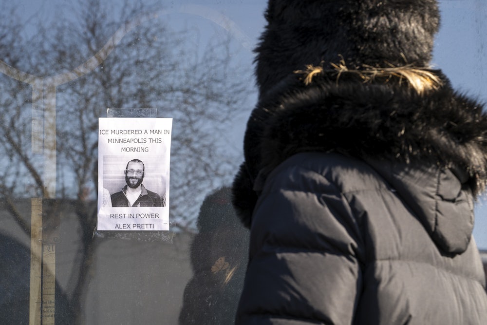 A person passes by a poster of Alex Pretti in Minneapolis. Pretti, an ICU nurse at a VA medical center, died on January 24 after being shot multiple times by U.S. Border Patrol agents in the Eat Street district of Minneapolis.