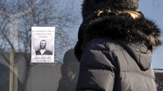 A person passes by a poster of Alex Pretti in Minneapolis. Pretti, an ICU nurse at a VA medical center, died on January 24 after being shot multiple times by U.S. Border Patrol agents in the Eat Street district of Minneapolis.
