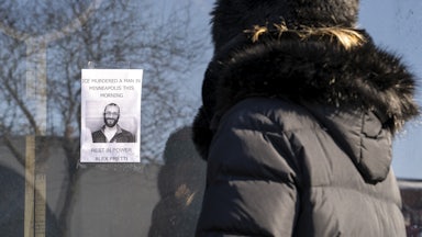 A person passes by a poster of Alex Pretti in Minneapolis. Pretti, an ICU nurse at a VA medical center, died on January 24 after being shot multiple times by U.S. Border Patrol agents in the Eat Street district of Minneapolis.