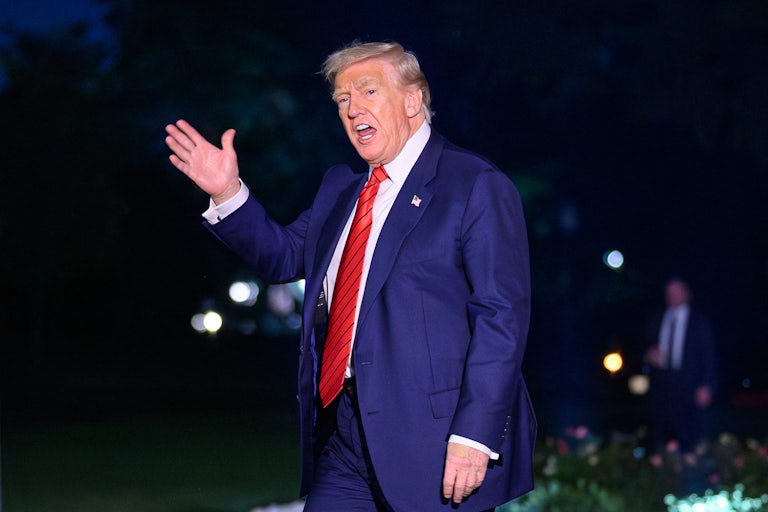 Donald Trump waves and speaks to reporters on the White House lawn