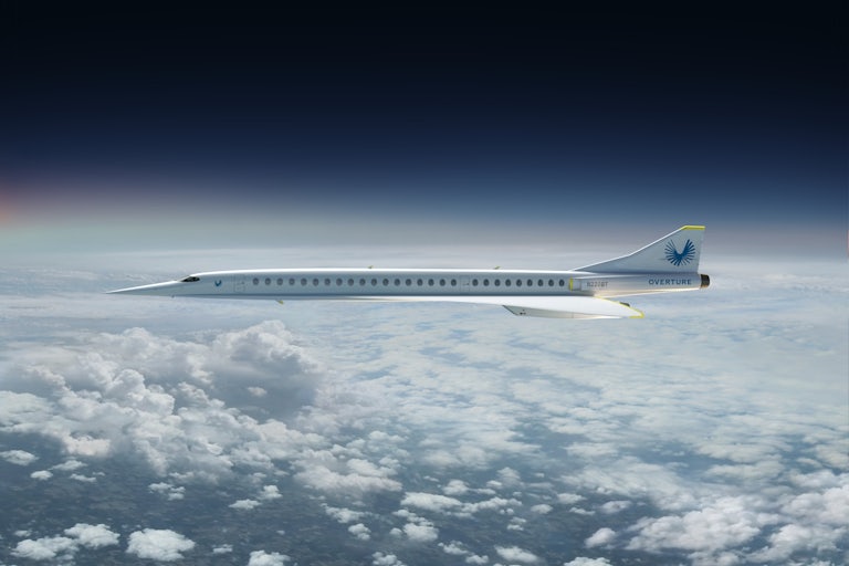 A long plane with a pointy nose is depicted over clouds.