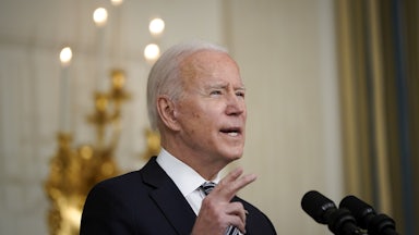 President Joe Biden speaks at a podium.