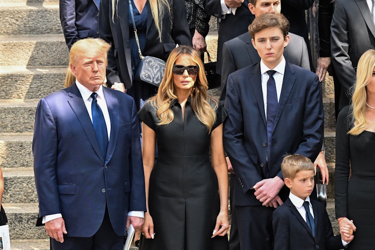 Donald Trump, Melania Trump, and Barron Trump stand next to each other