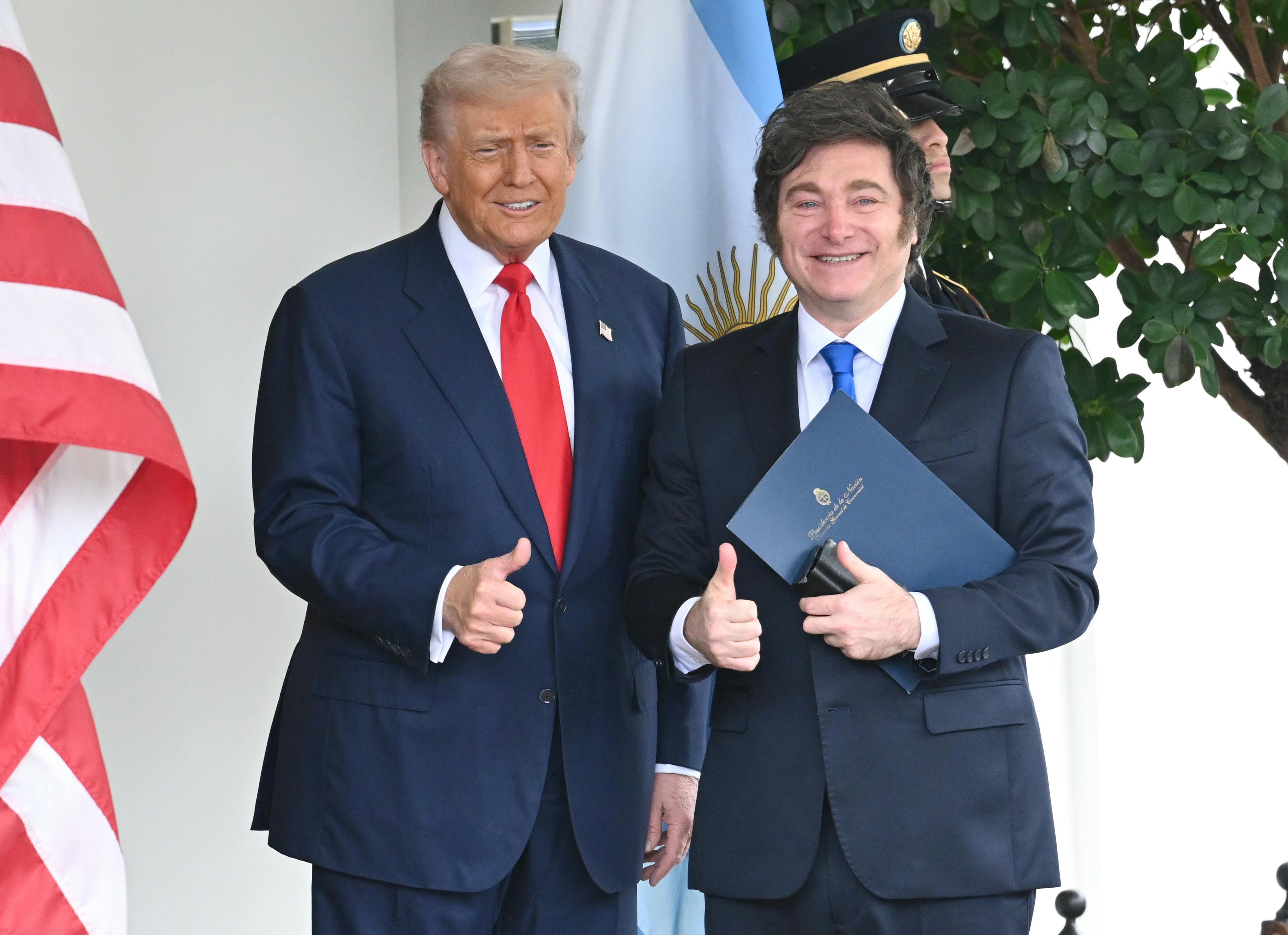 Donald Trump and Argentine President Javier Milei smile and make a thumbs up while standing outside the White House.