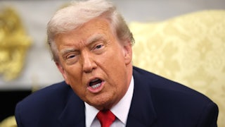 Donald Trump yells while seated in a chair in the Oval Office of the White House.