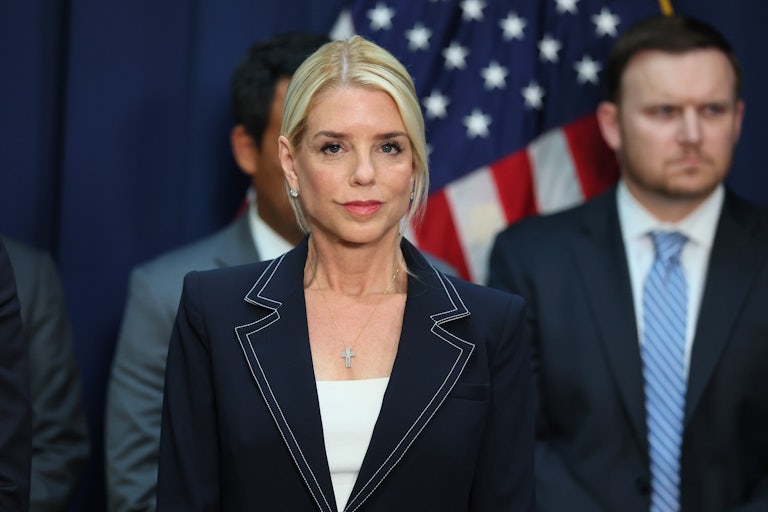 Attorney General Pam Bondi smiles slightly.
