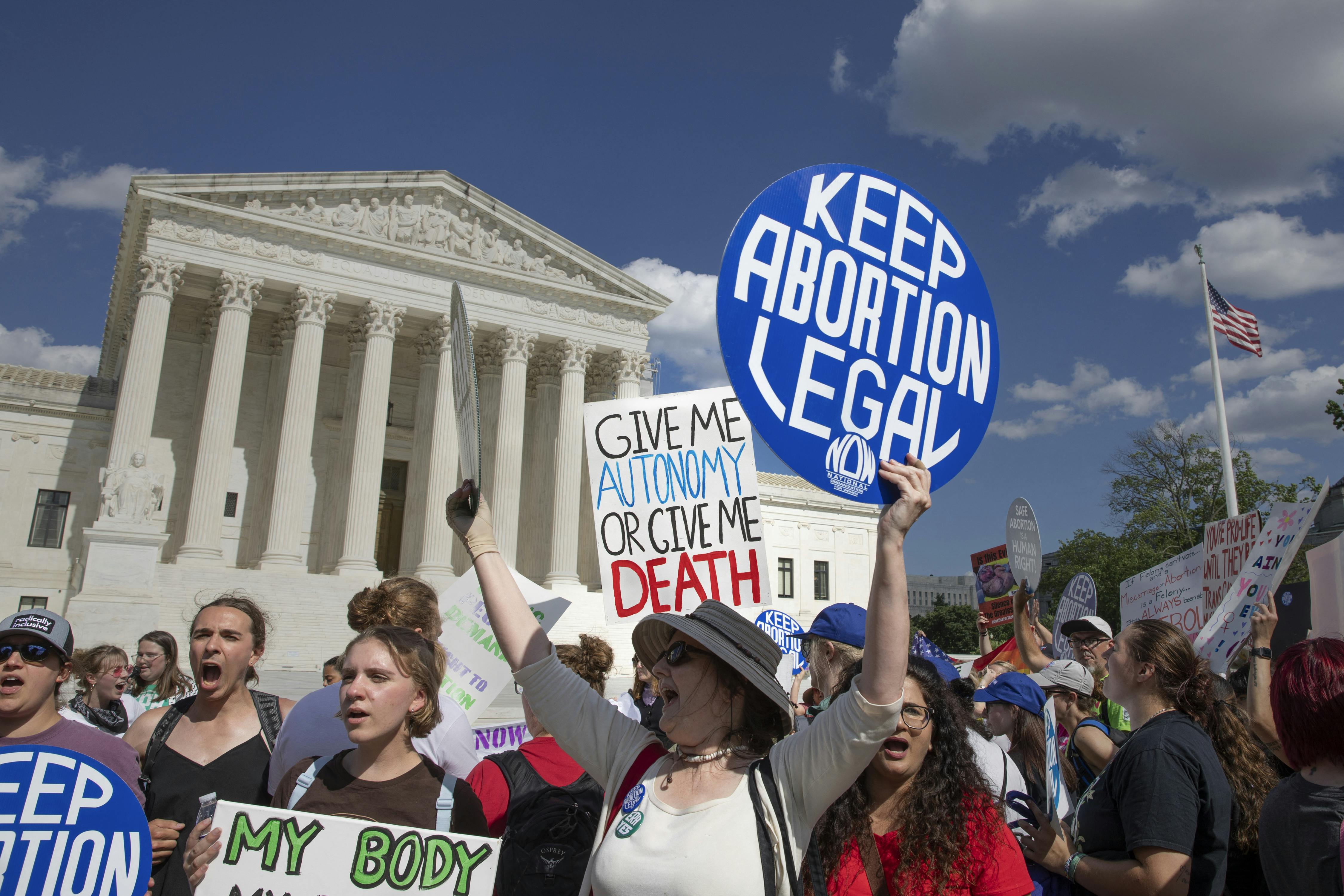 Women hold signs during an abortion rights demonstration in front of the U.S. Supreme Court in Washington, D.C.