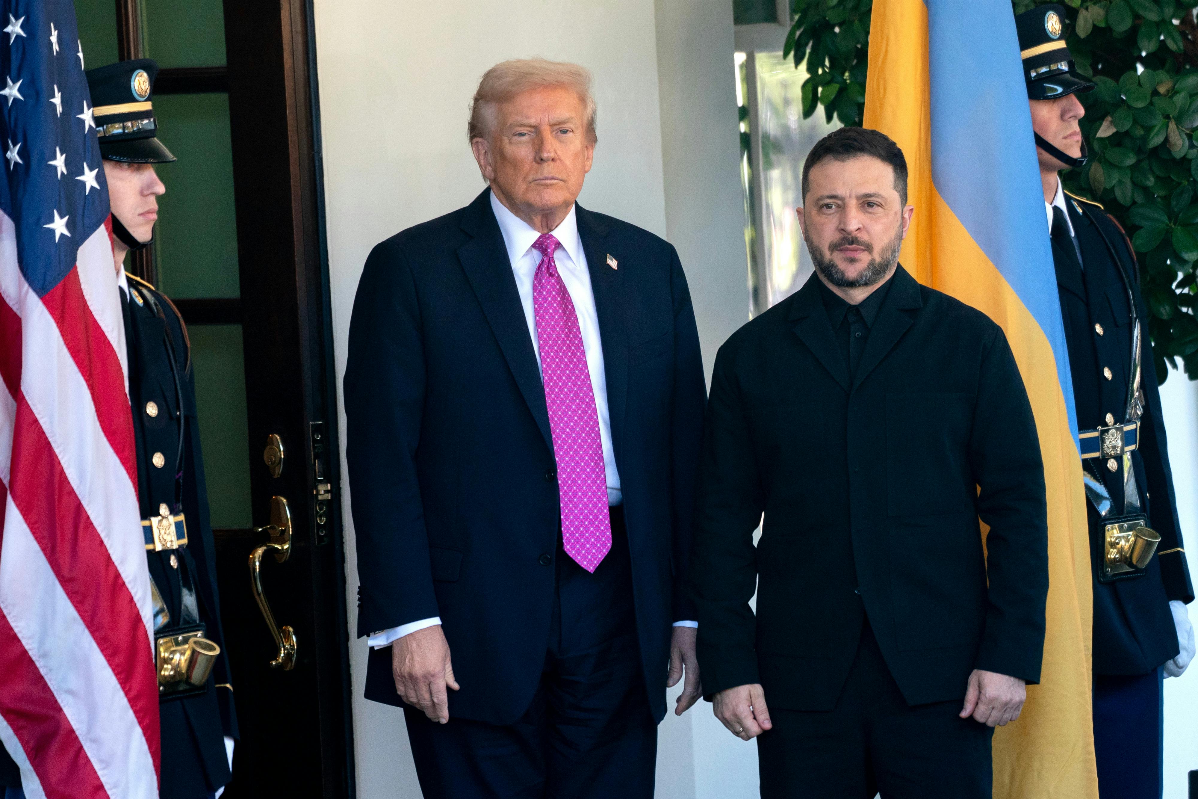 Donald Trump and Ukrainian President Volodymyr Zelenskiy stand next to each other at the White House entrance