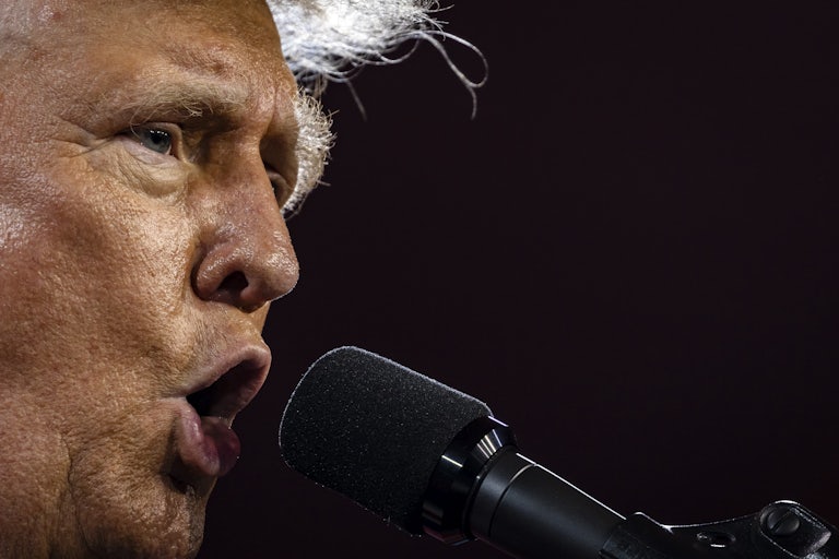 Donald Trump yells into a mic