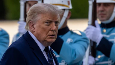Donald Trump turns his head to the side while walking in Ankara, Turkey