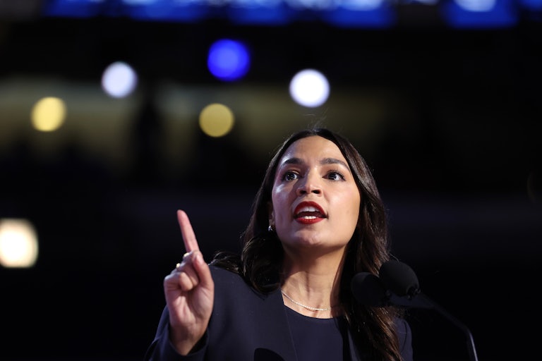 Alexandria Ocasio-Cortez points a finger as she speaks