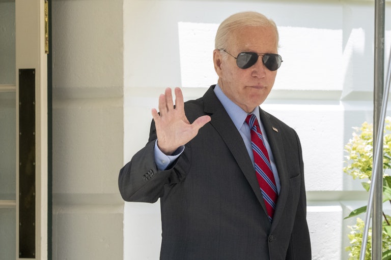 Joe Biden wears sunglasses and waves at the camera