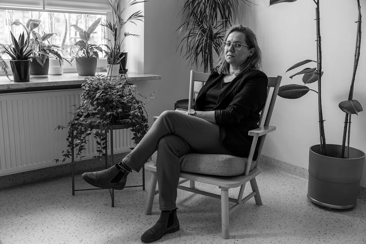 A black and white portrait of Izabela Zabielska, the deputy director of the Warsaw Family Assistance Center, a refugee housing facility in Warsaw, who worries about what will happen to the people living there now that special residency rights for Ukrainians are expiring: “It seems like we will be just throwing these people out the door" she says