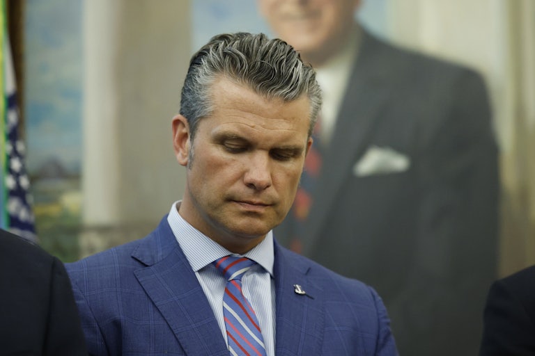 Pete Hegseth looks down