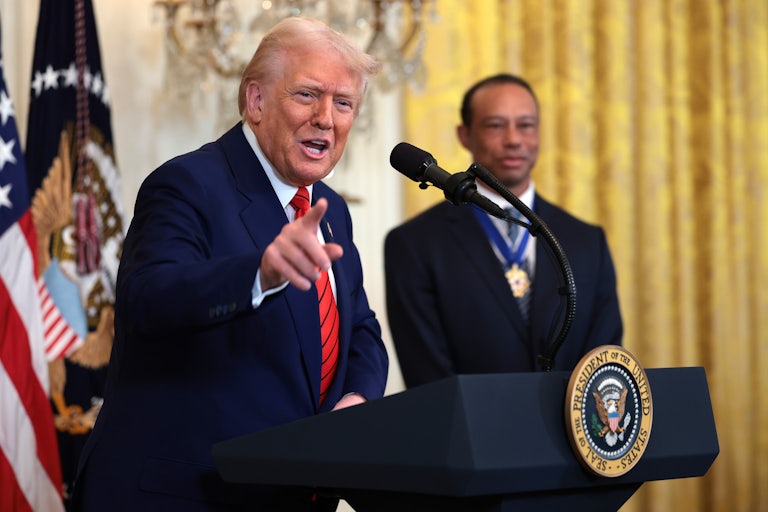 Donald Trump yells and points while speaking at the presidential podium.