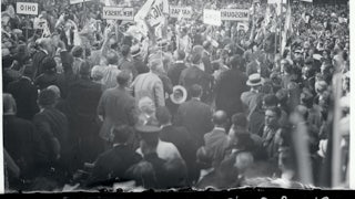Protesters with signs denouncing the Ku Klux Klan congregate at the 1924 Democratic National Convention.