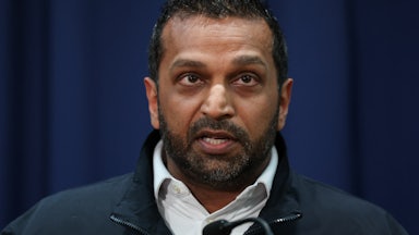 FBI Director Kash Patel looks up while speaking during a press conference