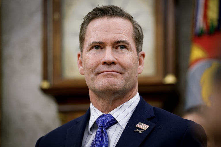 Trump White House national security adviser Mike Waltz smiles weirdly with his mouth closed.