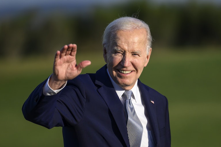 Joe Biden smiles and waves