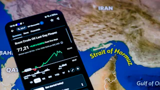 The Brent crude oil price chart from the past week is displayed on a mobile screen, with a map of the Strait of Hormuz in the background