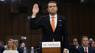 Acting Attorney General Todd Blanche holds his hand up as he's sworn in to his confirmation hearing in the Senate Judiciary Commitee