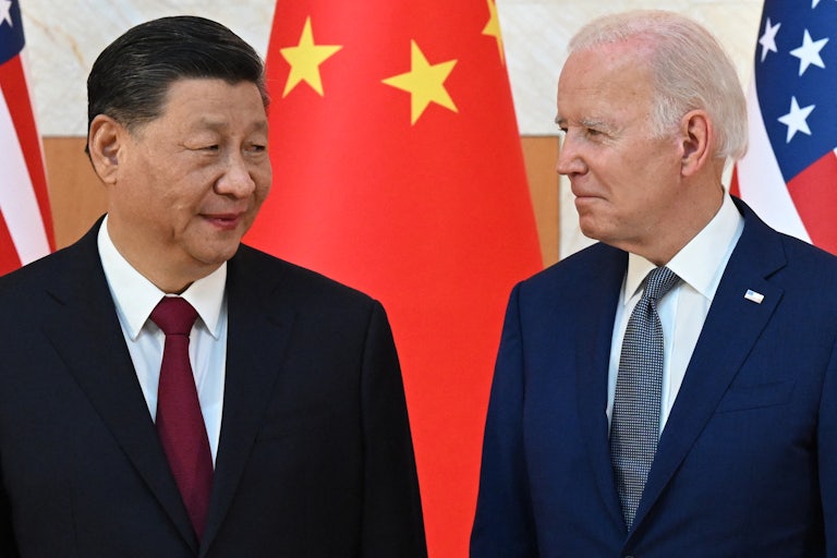 Xi Jinping and Joe Biden look at one another.