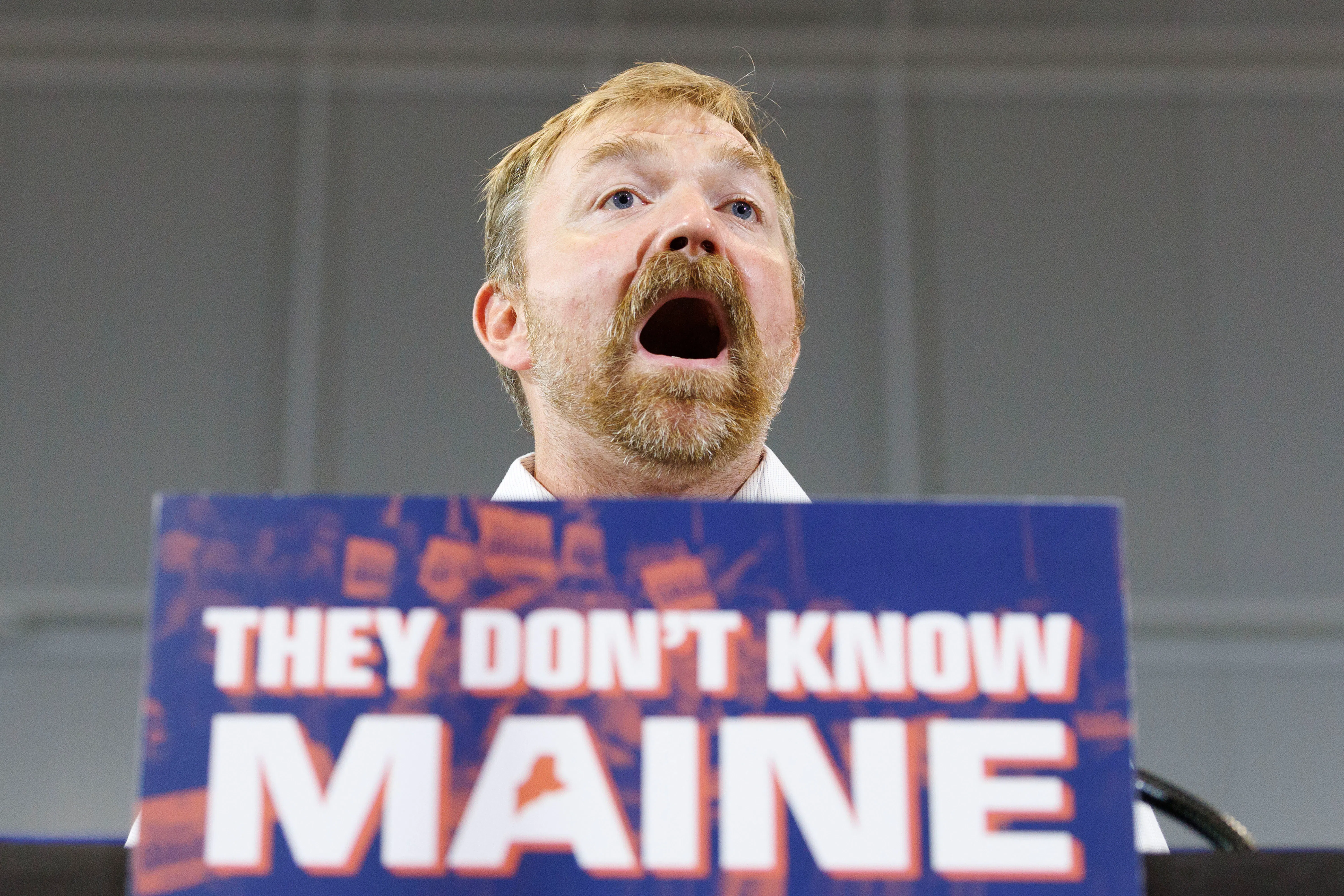 Maine Democratic Senate candidate Graham Platner speaks at a podium during a campaign event