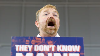 Maine Democratic Senate candidate Graham Platner speaks at a podium during a campaign event