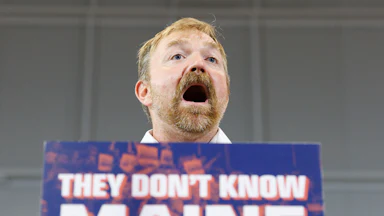 Maine Democratic Senate candidate Graham Platner speaks at a podium during a campaign event
