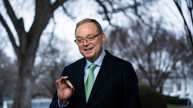 Kevin Hassett, director of the National Economic Council, speaks during an interview outside the White House, and makes an OK gesture with his hand.