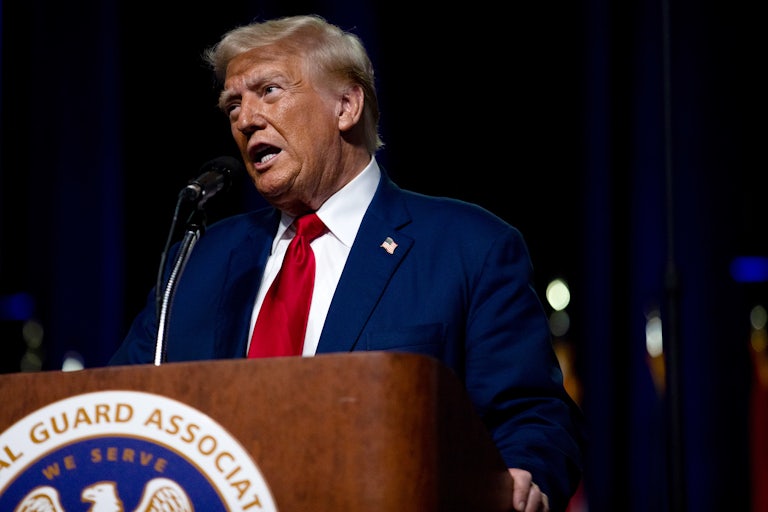 Donald Trump speaking at a lectern
