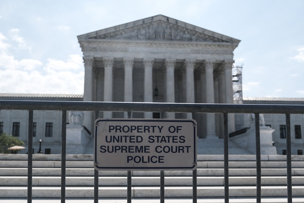 The Supreme Court building with security fencing in front of it.