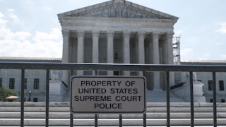 The Supreme Court building with security fencing in front of it.