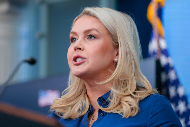 Press Secretary Karoline Leavitt speaks at a podium during a White House press briefing