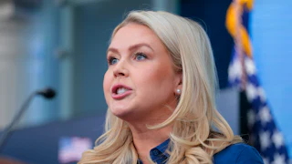 Press Secretary Karoline Leavitt speaks at a podium during a White House press briefing